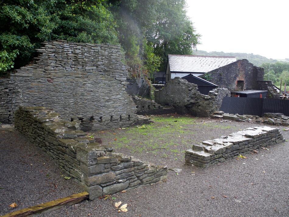 Another set of partially collapsed brick walls that form three walls of a room.